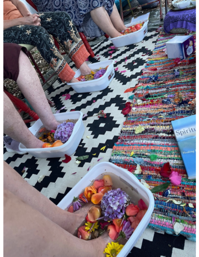 People using foot baths filled with flowers